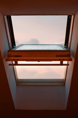 the open window of the attic in the evening