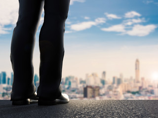rear view of 3d rendering businessman standing with cityscape background
