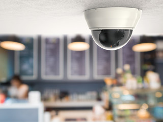 security camera or cctv camera on ceiling with retail shop background