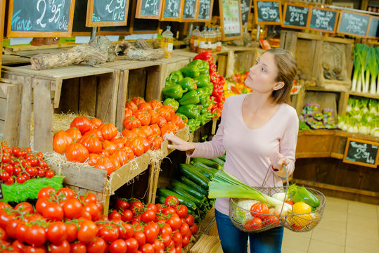 Woman browsing the organic section of a supermarket