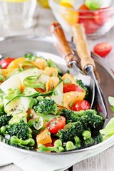 Summer vegetables salad with broccoli,zucchini,carrots,cherry tomatoes and green pea. Clean eating concept.Selective focus