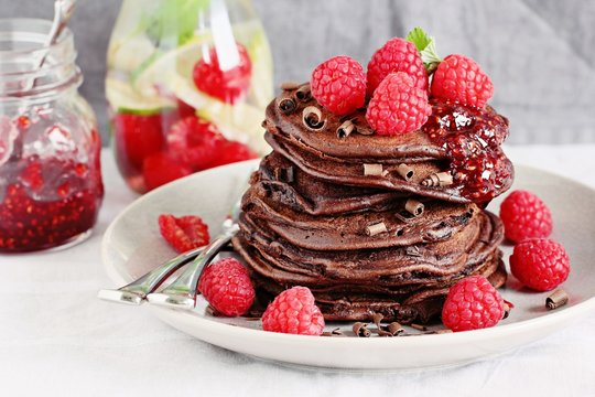 Chocolate pancakes with fresh raspberries. Selective focus 