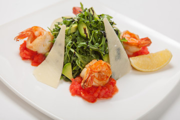 Arugula salad with avocado slices with Parmesan cheese and fried shrimp flavored with balsamic vinegar