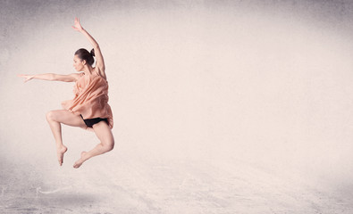 Naklejka na ściany i meble Modern ballet dancer performing art jump with empty background