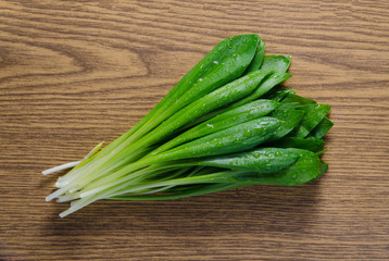 Ramson (bear garlic) bunch on wooden background