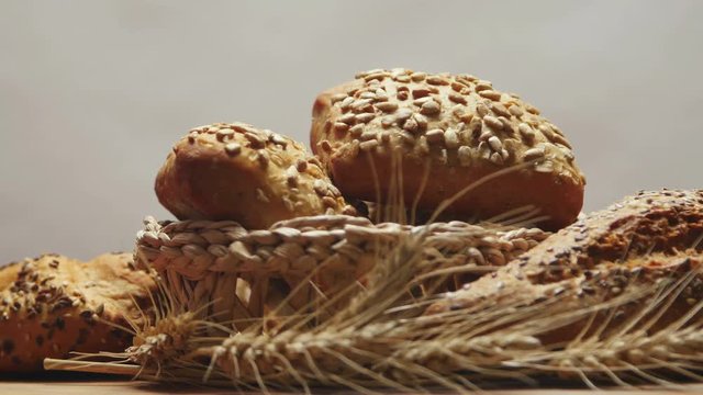 Bakery bread on a wooden table, rotating