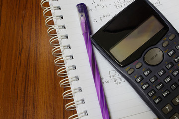 handheld calculator on a sheet of paper