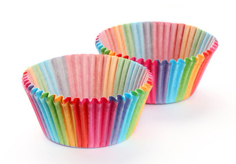 Colourful rainbow paper baking cases isolated on white