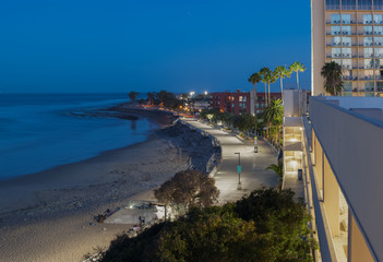 Panoramic view of concrete boardwalk along the beach at dawn.
