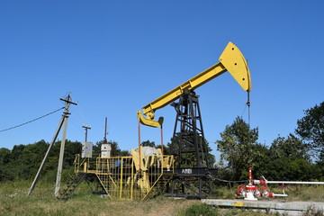 Fototapeta na wymiar Pumping unit as the oil pump installed on a well