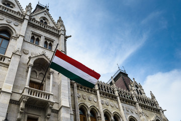 Fototapeta na wymiar Flag of Hungary an entrance to the Hungarian Parliament in Budapest.