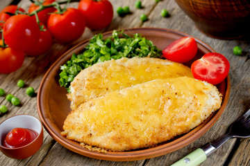 Chicken chop cutlet or schnitzel with cheese and green salad