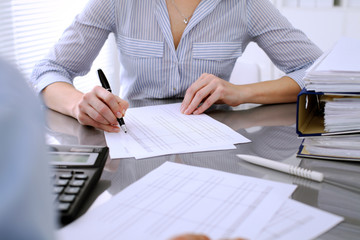 Bookkeepers or financial inspector making report, calculating or checking balance. Audit concept.