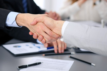 Close up of  two business man shaking hands to each other finishing up the meeting