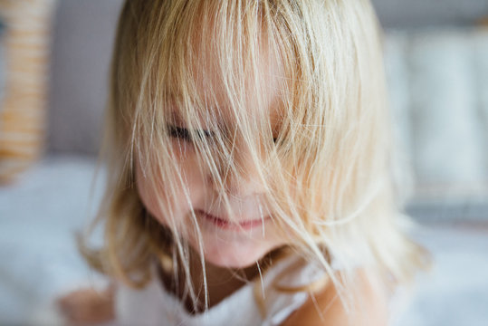 Portrait of girl with blonde hair covering face
