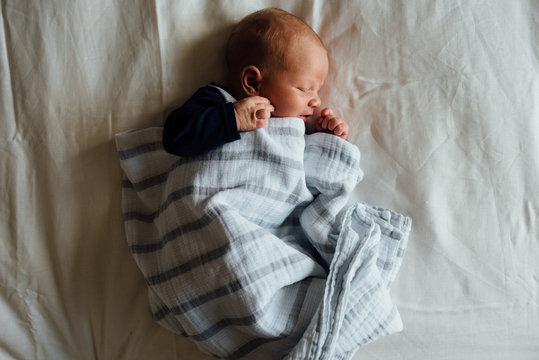 Newborn Baby Asleep On Bed