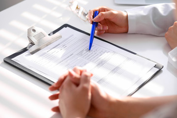 Doctor and patient are discussing something, just hands at the table