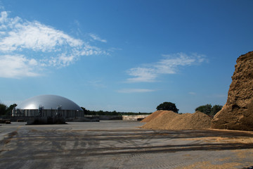 Fototapeta na wymiar biogas plant for renewable energy and biomass against the blue sky