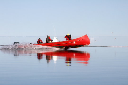 Red canoe in Arctic Ocean
