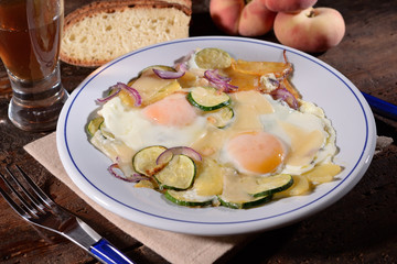 Fried eggs with zucchini and potatoes
