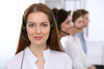 Fototapeta premium Call center operator.Young beautiful business woman in headset.