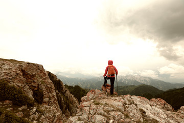 successful woman backpacke hiking  on mountain peak cliff