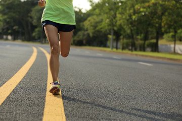 young fitness woman runner running on road