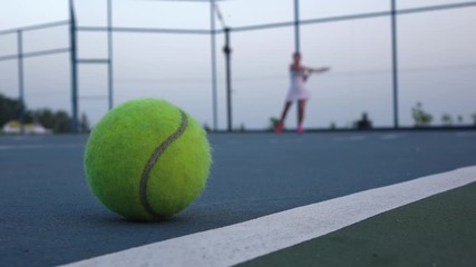 Tennis court with tennis balls and player