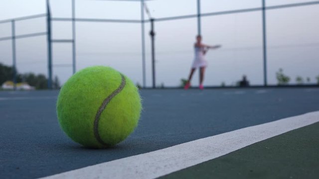 Tennis court with tennis balls and player
