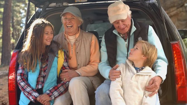 Grandparents and grandkids at the back of car before hiking