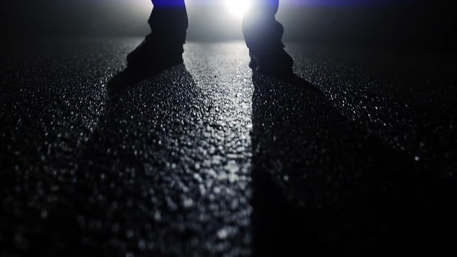 suspicious person standing outdoors in dark night. spooky scary background