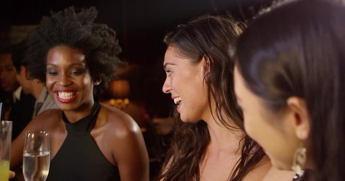 Female Friends Enjoy Night Out At Cocktail Bar 