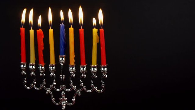 Chanukah candles all in a row. Bright, shiny multicolor candles for the Jewish holiday.