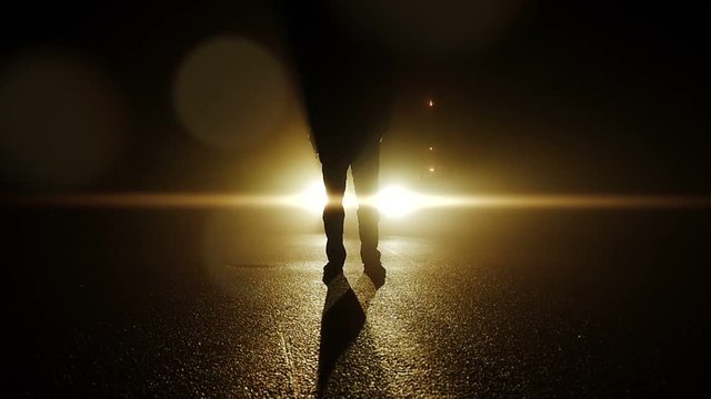 backlight silhouette of mystery person standing outdoors in dark night light