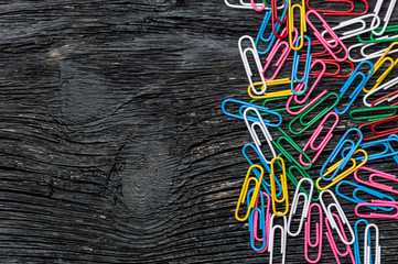 Colorful clips on wooden background