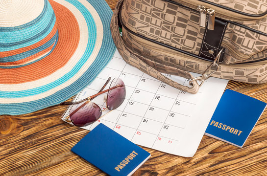 Vacation concept. Sunglasses, bag, hat and passports with calend