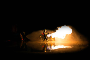 Obraz na płótnie Canvas Firefighter Fireman Attack Fire with High Pressure Water