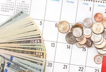 American banknotes and american coins on the calendar