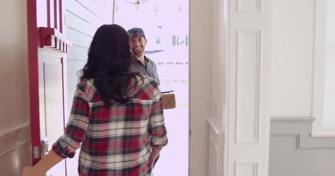 Woman Receiving Package To Courier At Home 