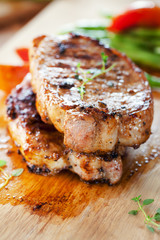 pork chops with vegetable on wooden board