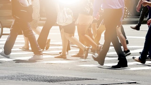 people walking on crowded street in the city. pedestrians commuters background