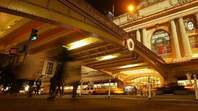 motion time lapse of people and traffic at night. grand central station new york