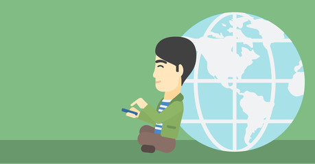 Businessman sitting near Earth globe.