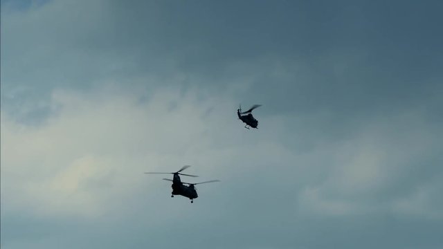 silhouette of flying military helicopter. war background