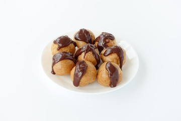 Profiteroles garnished with chocolate sauce