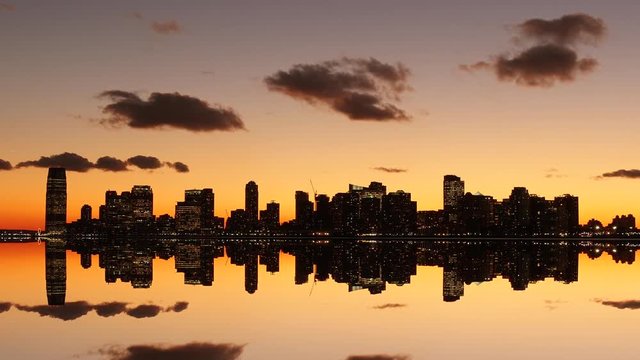 magic hour dusk sky light over cityscape skyline silhouette. mirror reflection