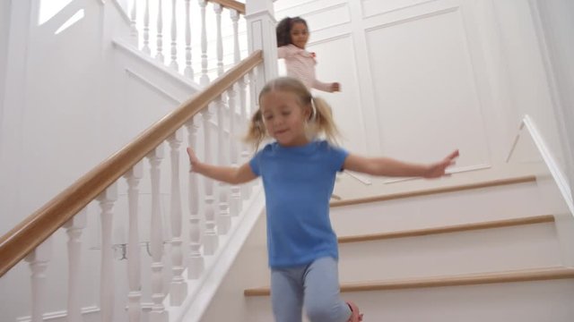 Two Girls Running Down Staircase Shot In Slow Motion
