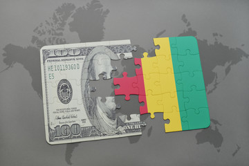 puzzle with the national flag of guinea and dollar banknote on a world map background.