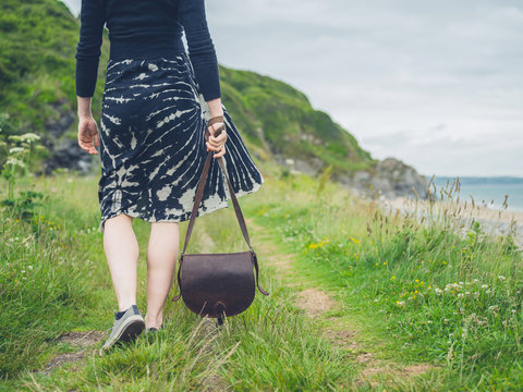 Young woman with handbag in nature