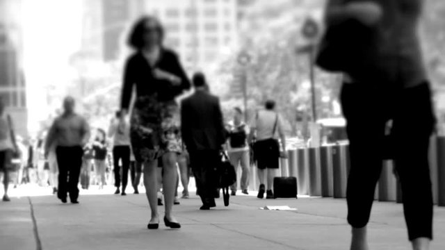 people walking on crowded street in the city. pedestrians commuters background